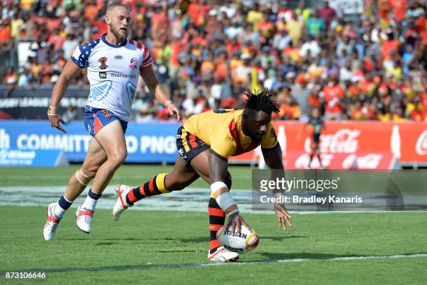James Segeyaro of Papua New Guinea scores a try during the 2017 Rugby League World Cup match between Papua New Guinea and the United States on...