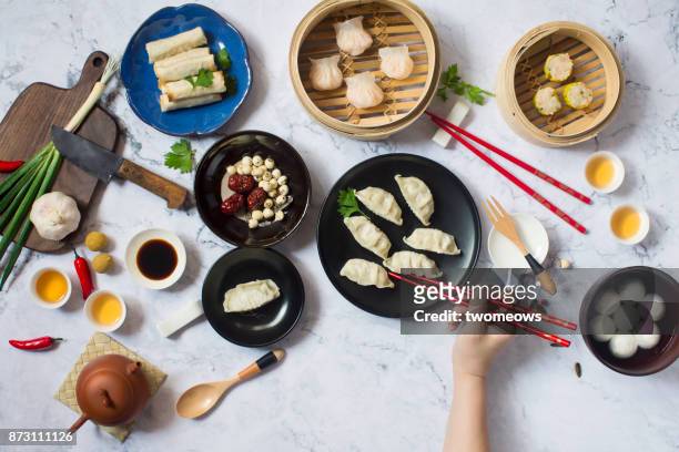 flat lay chinese new year reunion dinner, food and drink. marble top background. - lunar new year cup 2017 stock-fotos und bilder