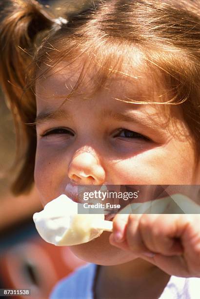 little girl eating ice cream - girl eating frozen treat stock pictures, royalty-free photos & images
