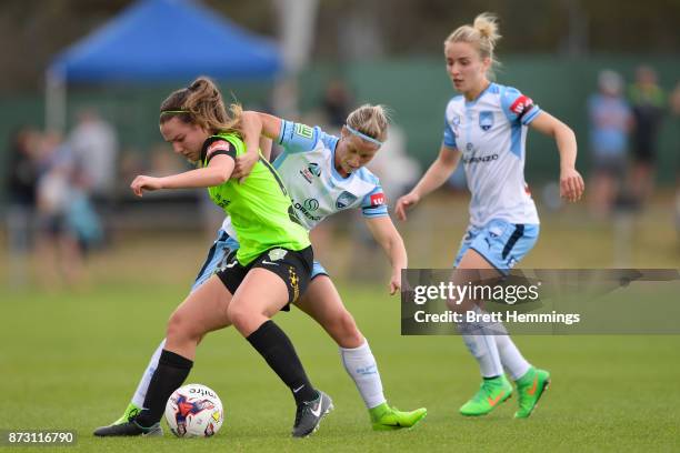 Grace Maher of Canberra is tackled by Kylie Ledbrook of Sydney during the round three W-League match between Canberra United and Sydney FC at...