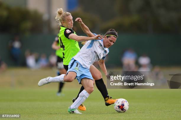 Lisa De Vanna of Sydney is tackled by Laura Bassett of Canberra during the round three W-League match between Canberra United and Sydney FC at...