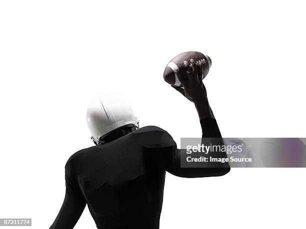 an american football player holding a football - american football player isolated stock pictures, royalty-free photos & images