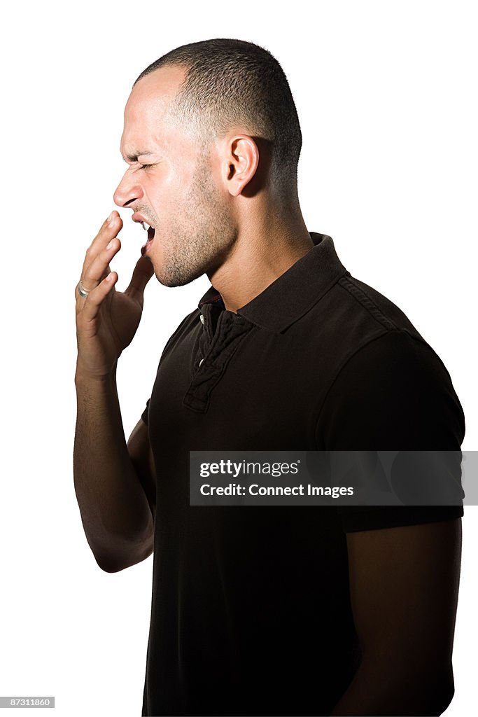 Young man yawning