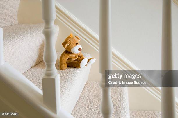 soft toy on stairs - carpet stairs stock-fotos und bilder