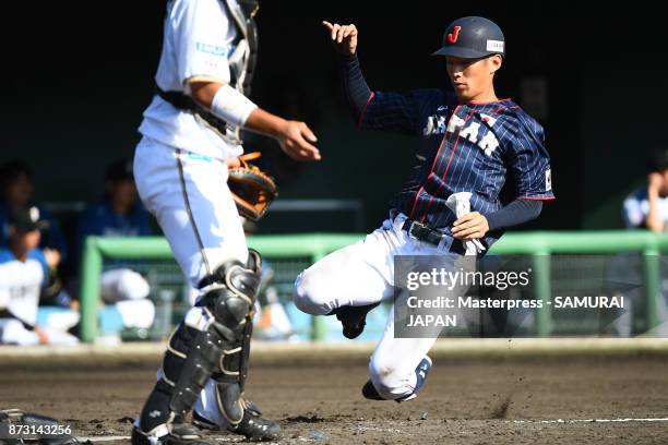 Yota Kyoda of Samurai Japan scores a run during the practice game between Japan and Hokkaido Nippon Ham Fighters at Sokken Stadium on November 12,...