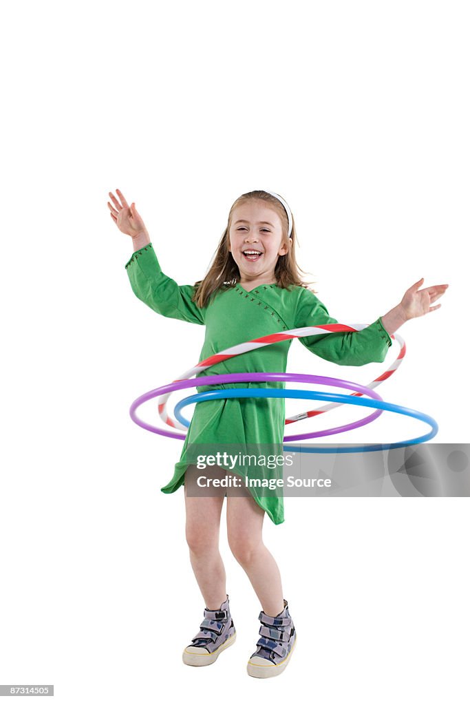 A girl playing with a plastic hoop