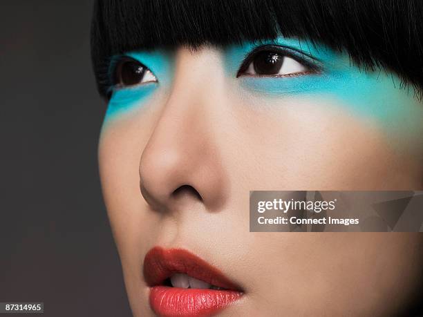 woman with turquoise eyeshadow - asian model stock pictures, royalty-free photos & images