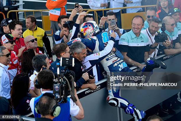 Del Conca Gresini Moto3 Spanish rider Jorge Martin celebrates with his team after winning the Moto3 race of the Valencia Grand Prix at Ricardo Torto...