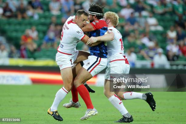 Antoni Maria of France is tackled by James Roby and James Graham of England during the 2017 Rugby League World Cup match between England and France...
