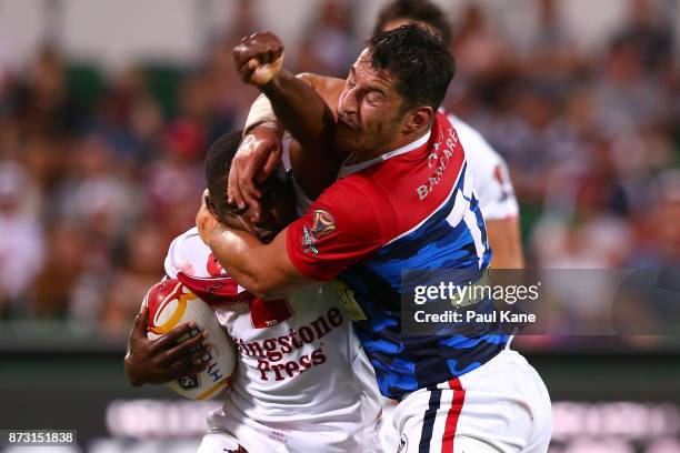 Jermaine McGillvary of England gets tackled by Remy Marginet of France during the 2017 Rugby League World Cup match between England and France at nib...