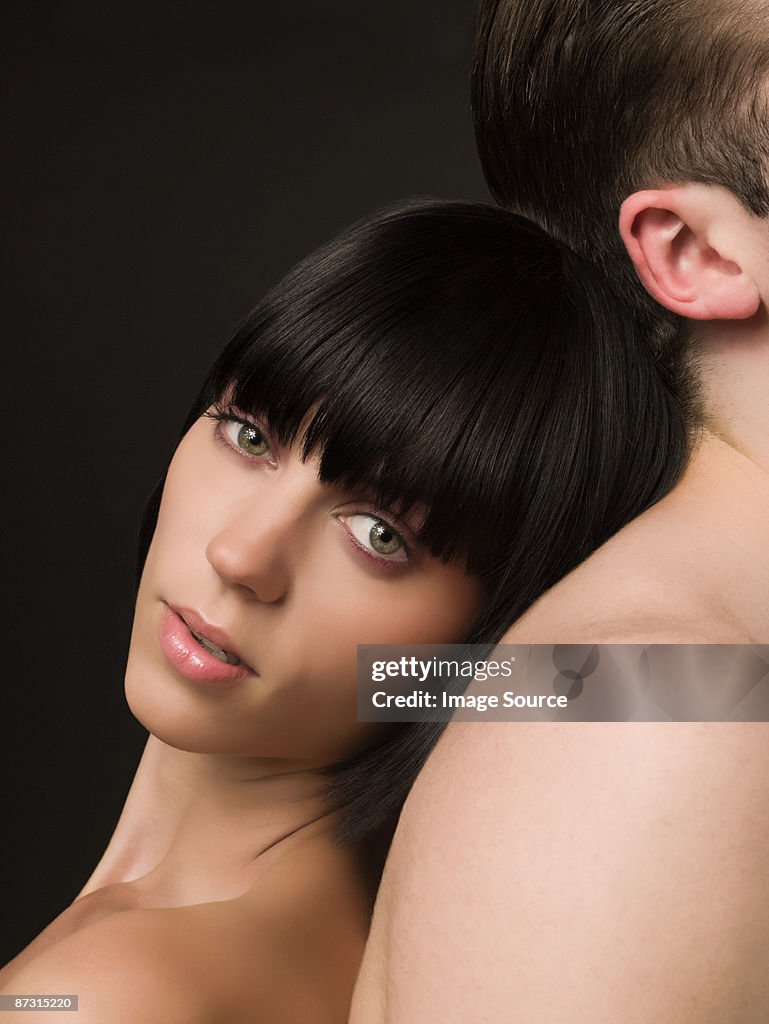 Woman leaning on male back