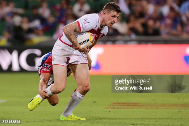 Mark Percival of England is tackled by Bastien Ader of France during the 2017 Rugby League World Cup match between England and France at nib Stadium...