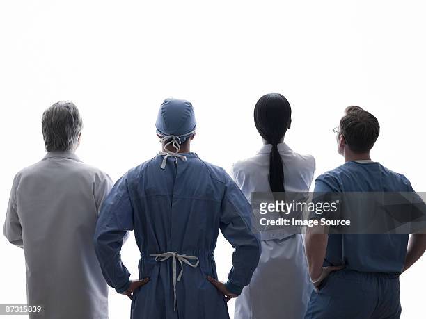 rear view of medical professionals - four people stock pictures, royalty-free photos & images