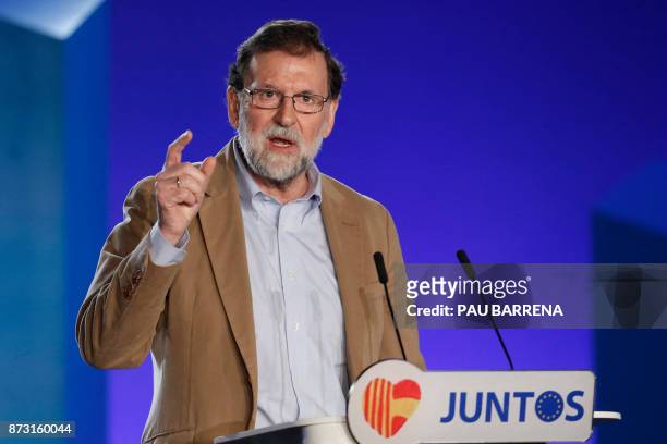 Spanish Prime Minister Mariano Rajoy gives a speech during a meeting to support his Popular Party candidate in next month's vote, in Barcelona on...