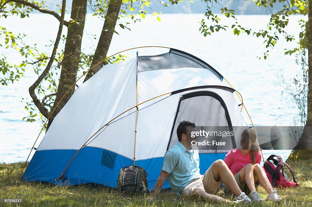 Portrait of a couple camping beside a lake