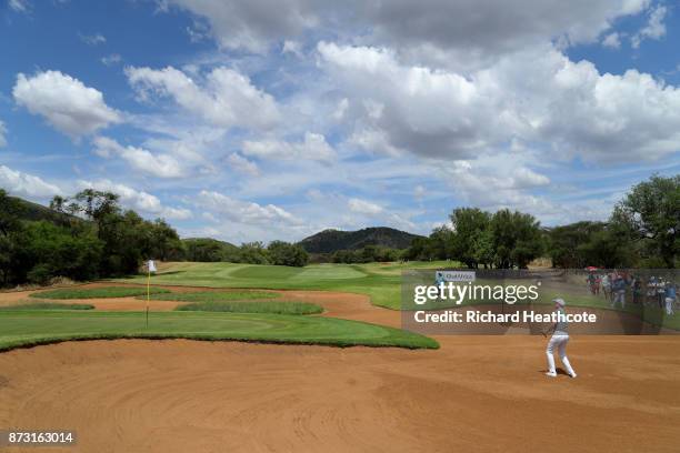 Ross Fisher of England hits from a bunker on the 14th hole during the final round of the Nedbank Golf Challenge at Gary Player CC on November 12,...