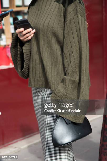 Fashion stylist and consultant Kate Foley Osterweis wears a Mother of Pearl sweater, Calvin Klein bag and a Miu Miu skirt day 4 of Paris Womens...