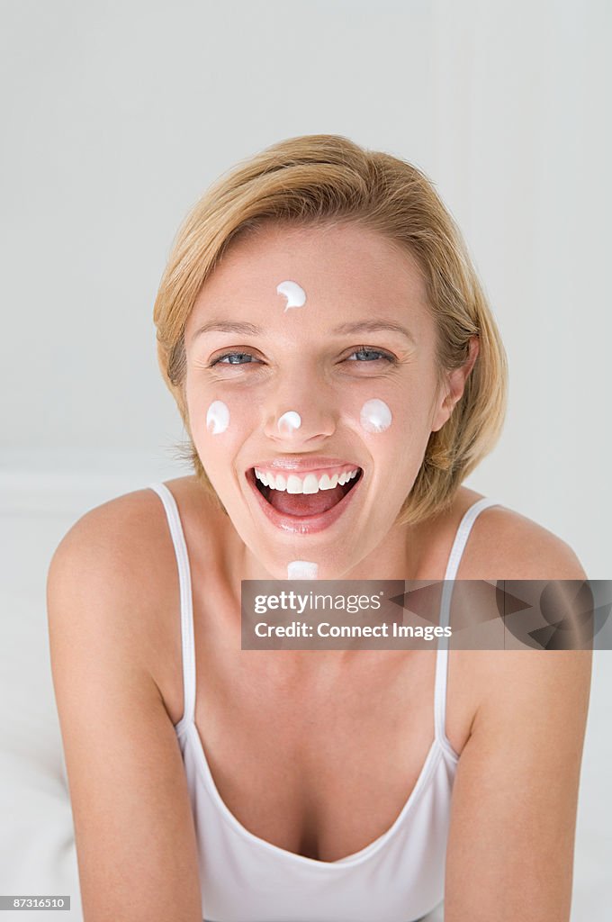 Portrait of a woman with moistriser dotted on her head