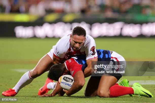 Mickael Rouch of France is tackled by Luke Gale of England during the 2017 Rugby League World Cup match between England and France at nib Stadium on...