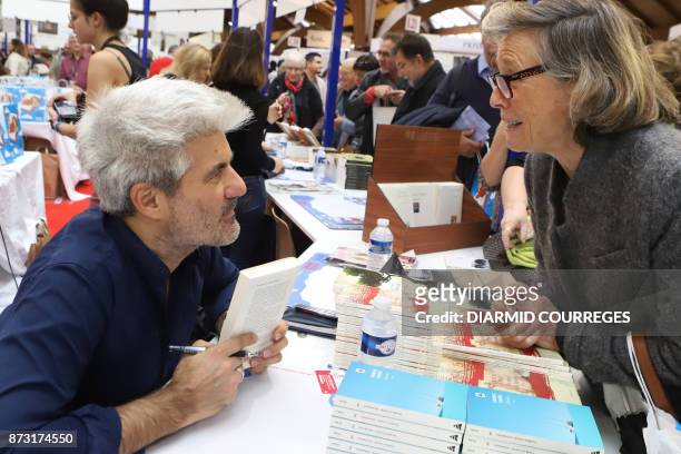 French writer Laurent Gaude, President of the 36th edition of the "Foire du Livre de Brive" book fair, meets readers on November 12, 2017 in...