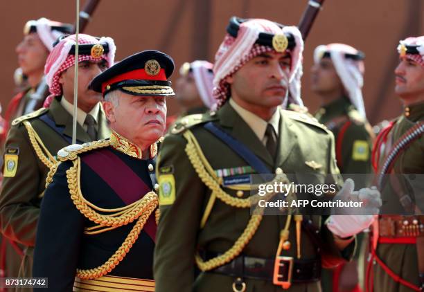 Jordan's King Abdullah II reviews the honour guard upon his arrival at parliament, as he opens the regular session in the capital Amman on November...