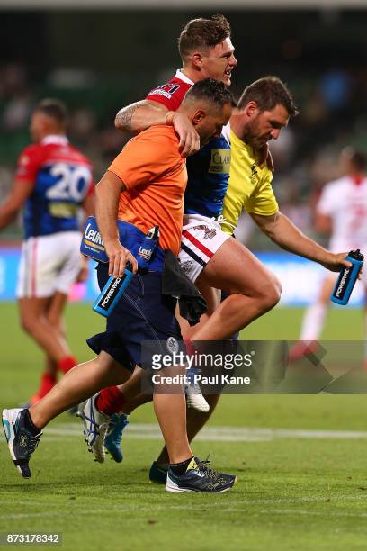 Thibault Margalet of France is assisted from the field during the 2017 Rugby League World Cup match between England and France at nib Stadium on...