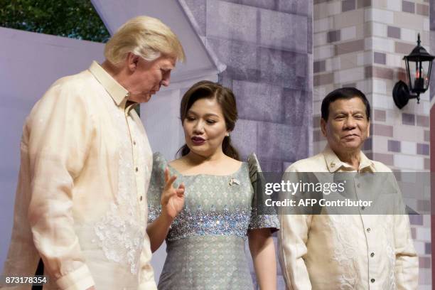 President Donald Trump listens to Honeylet Avancena , partner of Philippine President Rodrigo Duterte upon arriving for the special gala celebration...