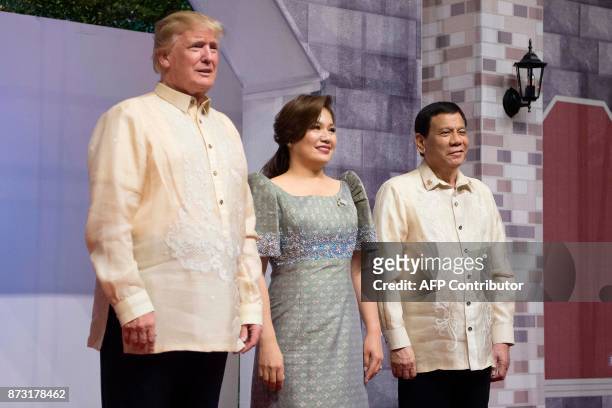 President Donald Trump poses with Honeylet Avancena , partner of Philippine President Rodrigo Duterte upon arriving for the special gala celebration...