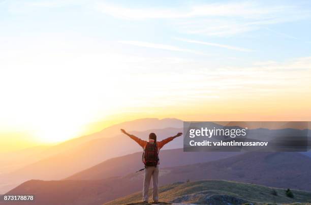 cheerful woman on top mountain - arms raised sunrise stock pictures, royalty-free photos & images