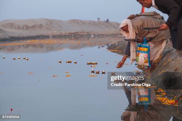 man performs a ritual puja with candle in vrindavan. india - rishikesh stock pictures, royalty-free photos & images