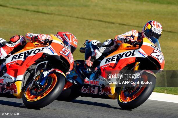 Repsol Honda Team's Spanish rider Marc Marquez and Repsol Honda Team's Spanish rider Dani Pedrosa ride during the MotoGP race of the Valencia Grand...