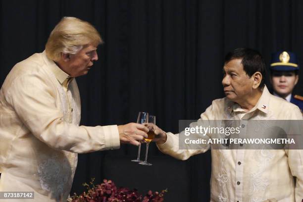 President Donald Trump toasts with Philippines President Rodrigo Duterte during a special gala celebration dinner for the Association of Southeast...