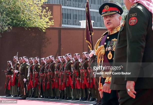 Jordan's King Abdullah II reviews the honour guard upon his arrival at parliament, as he opens the regular session in the capital Amman on November...