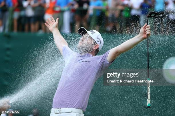 Branden Grace of South Africa is sprayed with champagne after his victory on the 18th green during the final round of the Nedbank Golf Challenge at...