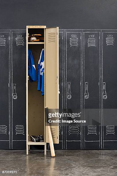 baseball uniform hanging in a closet - sports equipment locker stock pictures, royalty-free photos & images