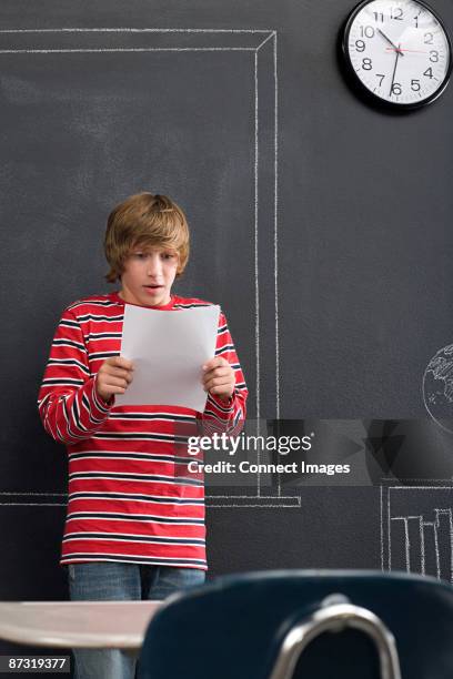 a boy giving a presentation - solo bambini maschi foto e immagini stock