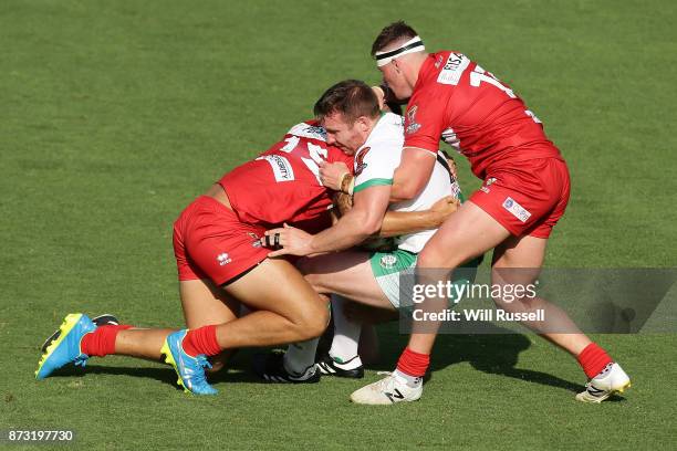 Matty Hadden is tackled by Gavin Bennion and Morgan Knowles of Wales during the 2017 Rugby League World Cup match between Wales and Ireland at nib...