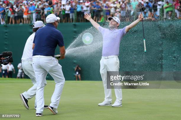Branden Grace of South Africa is sprayed with champagne on the 18th green during the final round of the Nedbank Golf Challenge at Gary Player CC on...
