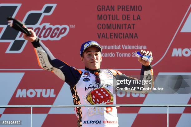 Repsol Honda Team's Spanish rider Marc Marquez celebrates on the podium after the MotoGP race of the Valencia Grand Prix at Ricardo Tormo racetrack...