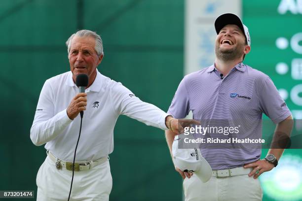 Branden Grace of South Africa reacts to Gary Player on the 18th green during the final round of the Nedbank Golf Challenge at Gary Player CC on...