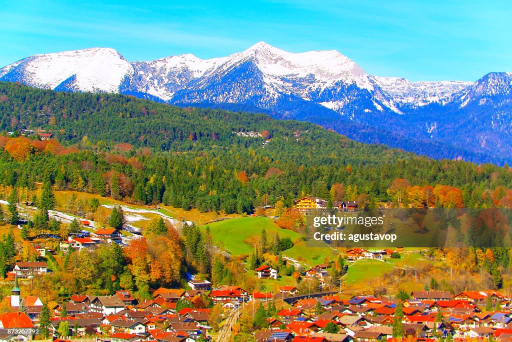 Above Mittenwald Alpine village – dramatic landscape in Bavarian alps in Germany, near Karwendel mountain range and border with Austria - Majestic alpine landscape in gold colored autumn, dramatic Snowcapped mountains and lakes panorama