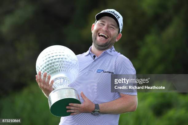 Branden Grace of South Africa poses with the trophy after his victory during the final round of the Nedbank Golf Challenge at Gary Player CC on...