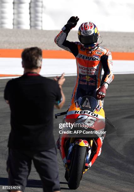 Repsol Honda's Spanish rider Dani Pedrosa celebrates after winning the MotoGP race of the Valencia Grand Prix at Ricardo Tormo racetrack in Cheste,...
