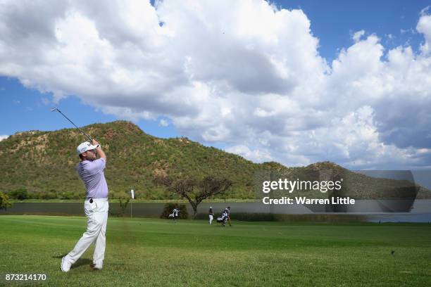 Branden Grace of South Africa plays his second shot into the 17th green during the final round of the Nedbank Golf Challenge at Gary Player CC on...