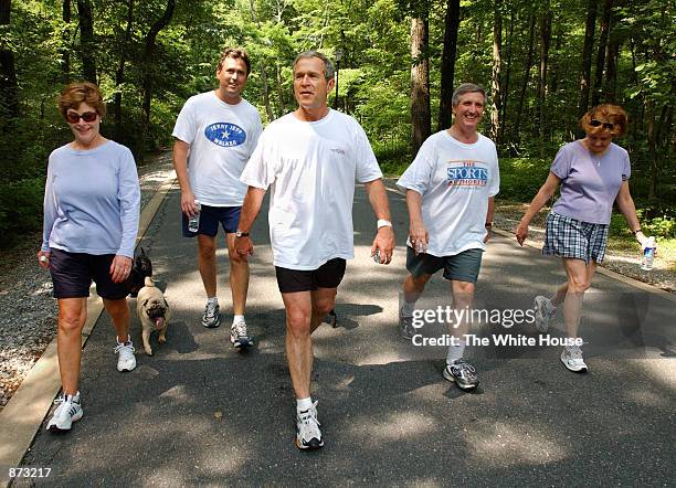 President George W. Bush takes a four mile walk, with first lady Laura Bush, brother Marvin Bush, Chief of Staff Andy Card and wife Kathleene, after...