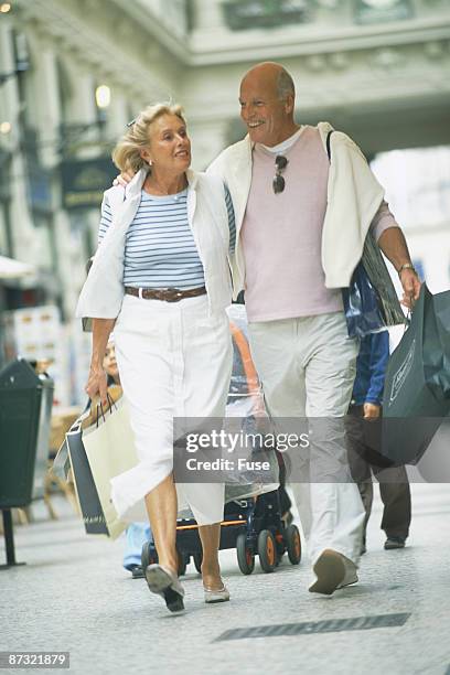 couple strolling through town - bald patch stock pictures, royalty-free photos & images