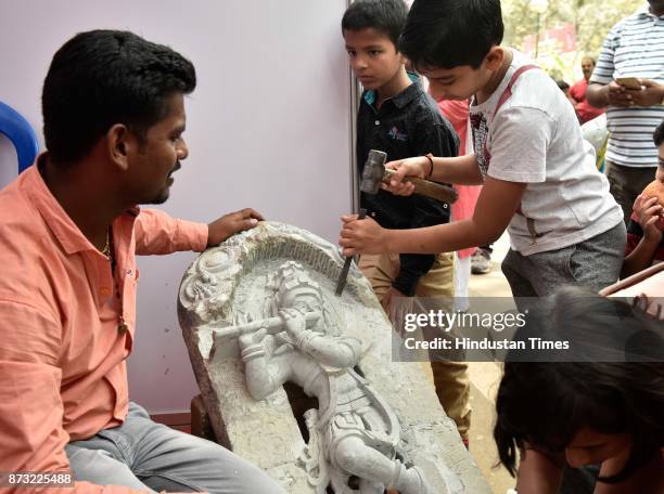 Children trying their hand in sculpting during Makkala Hanna, Children Festival at Cubbon Park, on November 12, 2017 in Bengaluru, India. Karnataka...