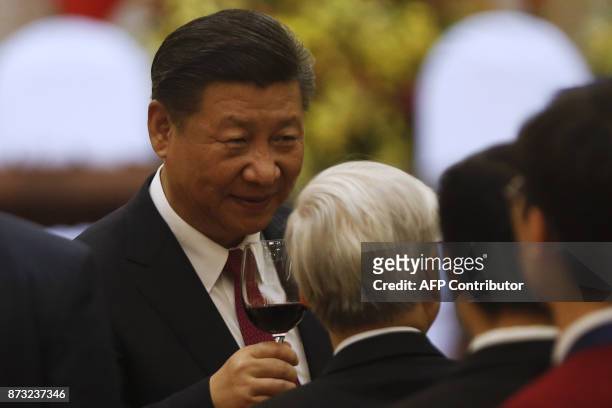 China's President Xi Jinping speaks with Vietnam's Communist Party General Secretary Nguyen Phu Trong at a state banquet to welcome him in Hanoi on...