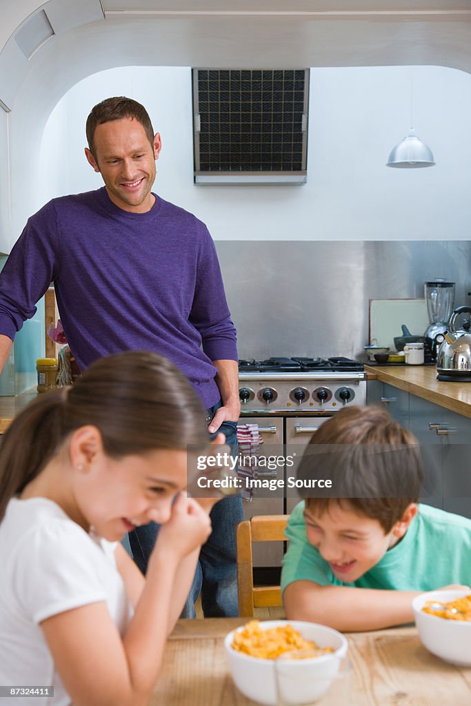 Family laughing at breakfast