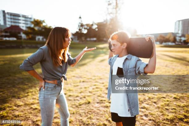 mother bothering the son with the skateboard - teenager arguing stock pictures, royalty-free photos & images